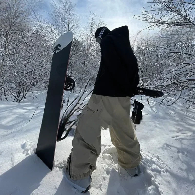 Model wearing Heronix khaki cargo snowpants with side pocket for skiing and snowboarding