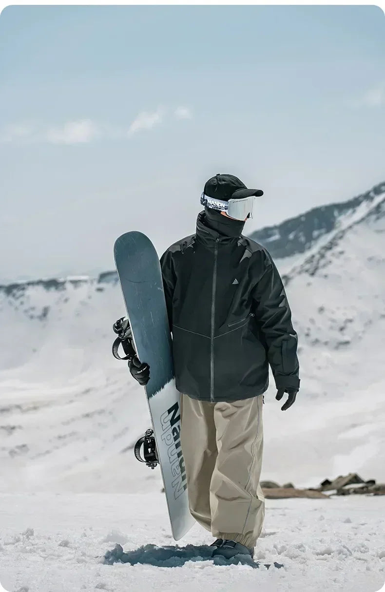 Model wearing Heronix khaki baggy snowpants for skiing and snowboarding